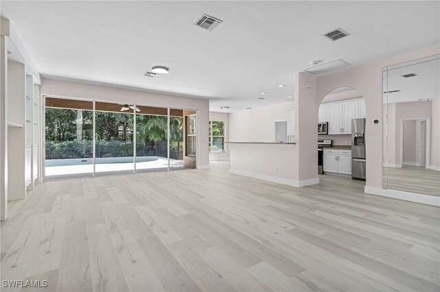 unfurnished living room with light wood-type flooring