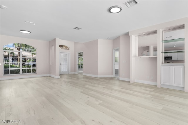 unfurnished living room featuring light wood-type flooring