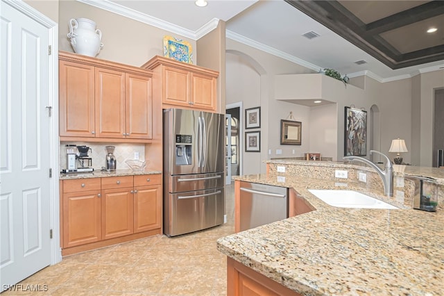 kitchen with light stone countertops, sink, stainless steel appliances, beamed ceiling, and ornamental molding