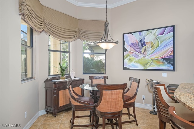 dining space featuring ornamental molding and light tile patterned floors