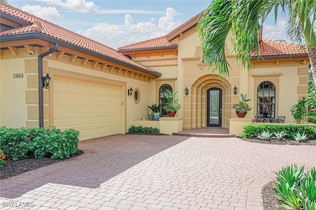 mediterranean / spanish-style home with a garage