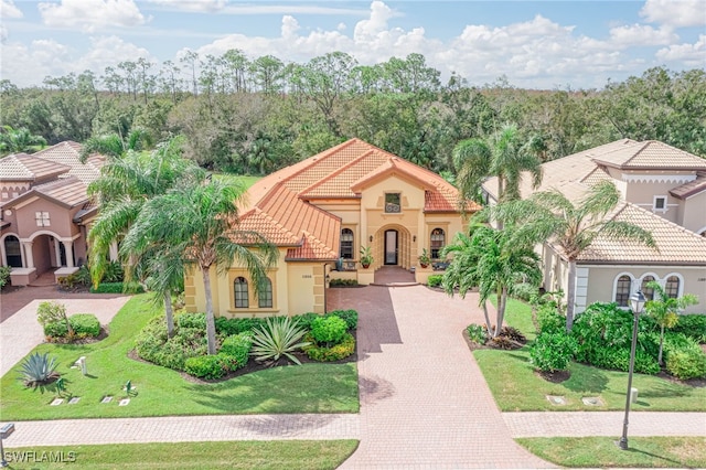 mediterranean / spanish-style house with a front yard