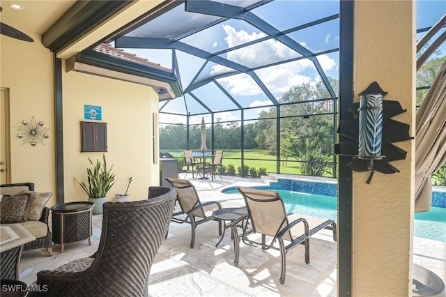 view of swimming pool featuring pool water feature, a patio, and a lanai