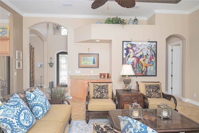 tiled living room featuring ornamental molding and ceiling fan