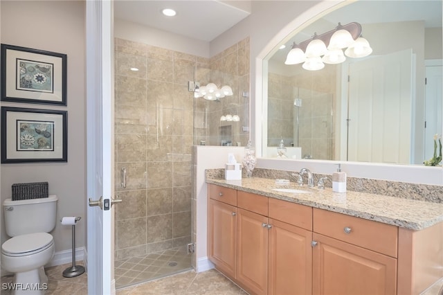 bathroom with toilet, vanity, tile patterned floors, and a shower with door