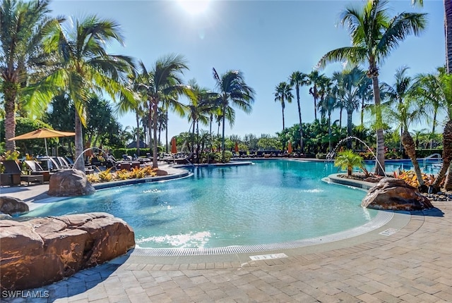 view of pool with a patio and pool water feature