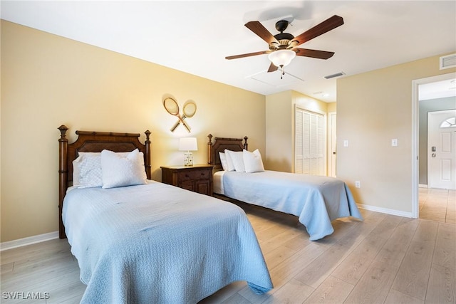 bedroom with ceiling fan, a closet, and light wood-type flooring