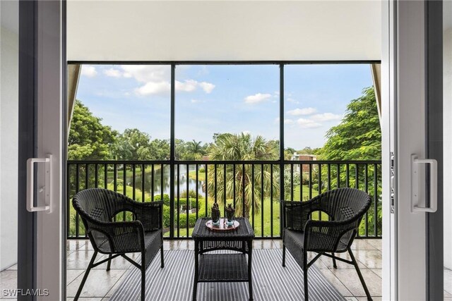 sunroom / solarium with a water view