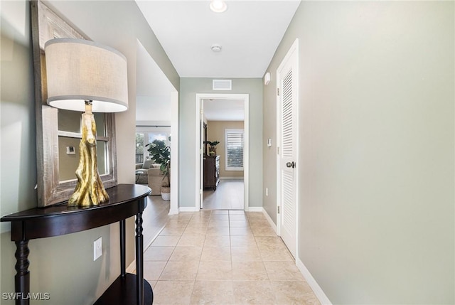 hall featuring light tile patterned flooring