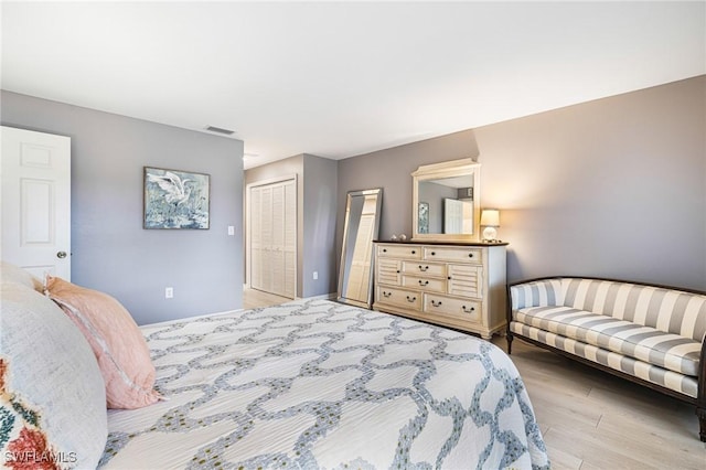 bedroom featuring light hardwood / wood-style floors and a closet