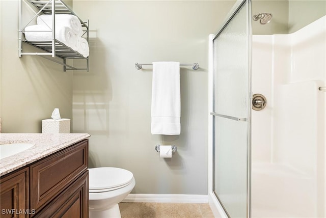 bathroom with vanity, an enclosed shower, and toilet