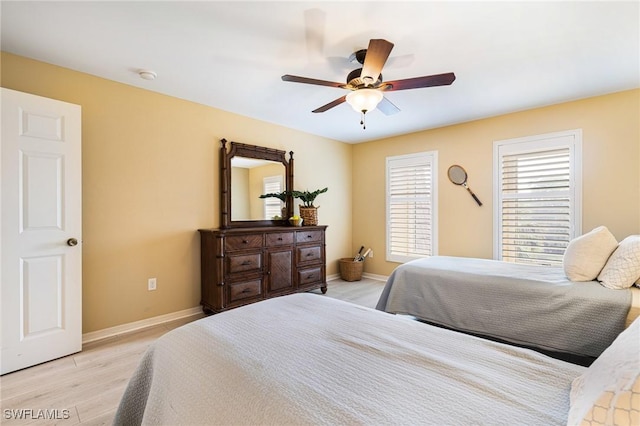 bedroom with ceiling fan and light hardwood / wood-style floors