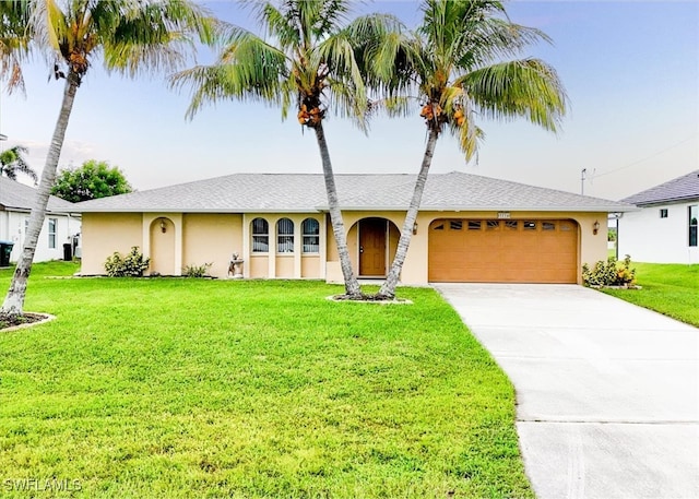 ranch-style home featuring a front yard and a garage