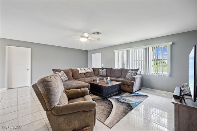 tiled living room featuring ceiling fan