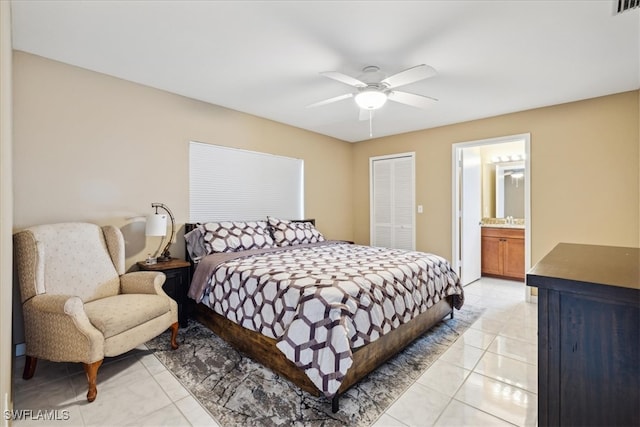 tiled bedroom with a closet, connected bathroom, and ceiling fan