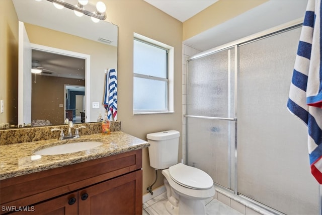 bathroom with ceiling fan, an enclosed shower, vanity, and toilet