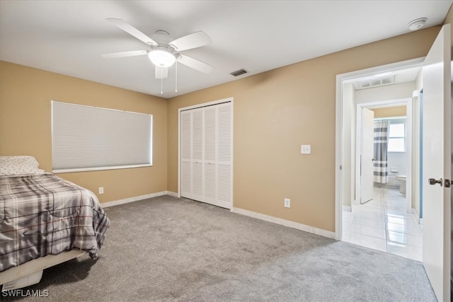 bedroom featuring a closet, ceiling fan, and light colored carpet