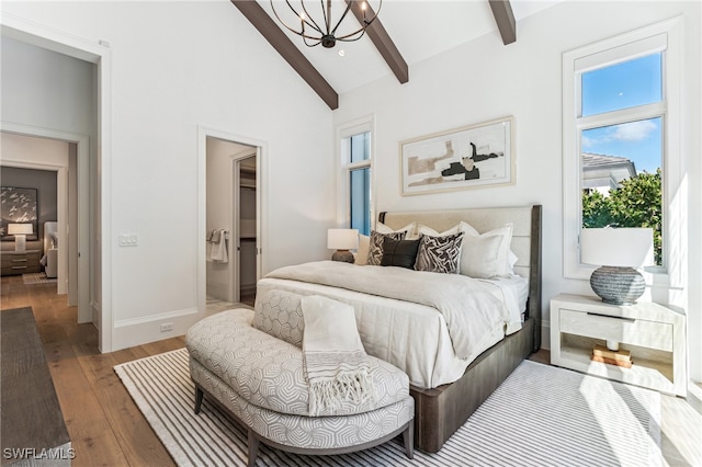 bedroom featuring hardwood / wood-style floors, high vaulted ceiling, ensuite bath, beamed ceiling, and a chandelier