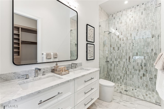 bathroom with vanity, toilet, and a shower with shower door