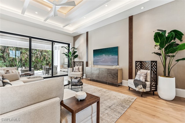 living room with beamed ceiling, coffered ceiling, and hardwood / wood-style flooring