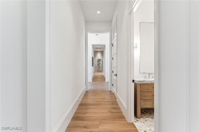 corridor with light wood-type flooring