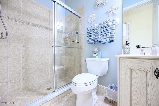 bathroom with toilet, vanity, tile patterned flooring, and a shower with door