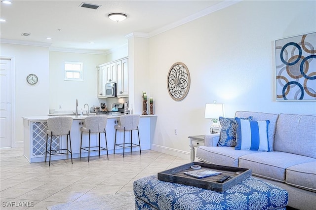 living room with light tile patterned floors and ornamental molding