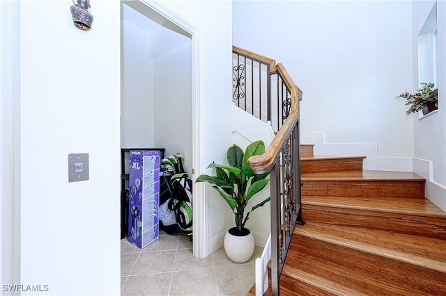 stairway with tile patterned flooring