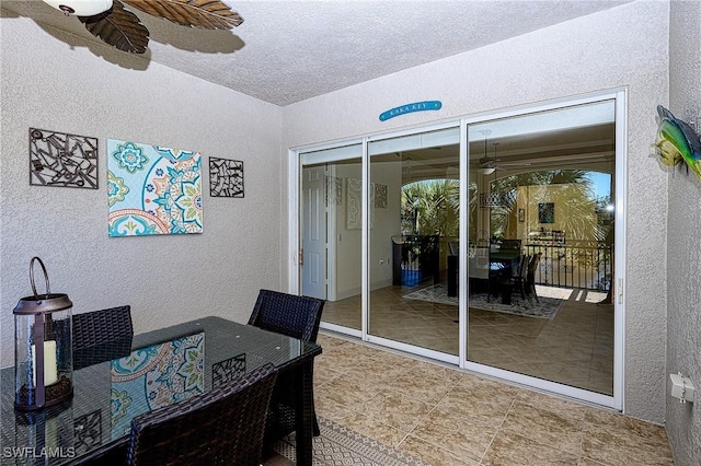 home office featuring ceiling fan and a textured ceiling