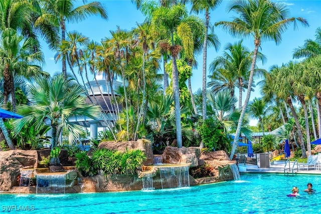 view of swimming pool with pool water feature