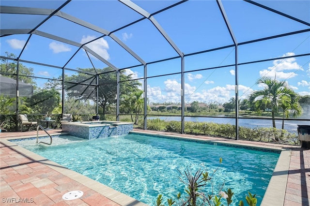 view of pool featuring glass enclosure, a water view, a patio, and an in ground hot tub