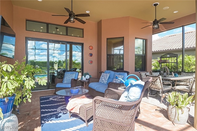 sunroom / solarium featuring ceiling fan and a wealth of natural light