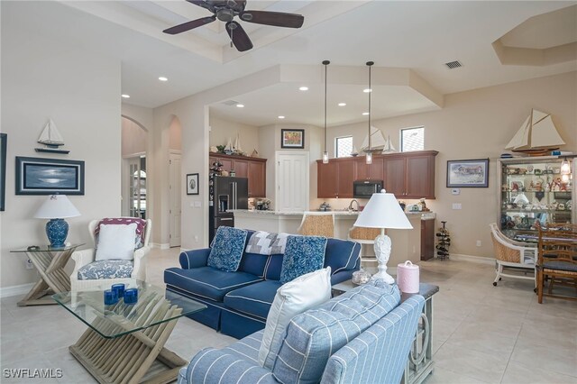 tiled living room with ceiling fan