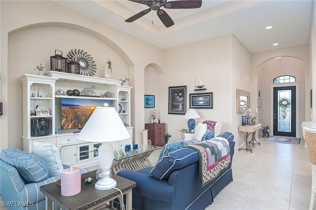 tiled living room with ceiling fan