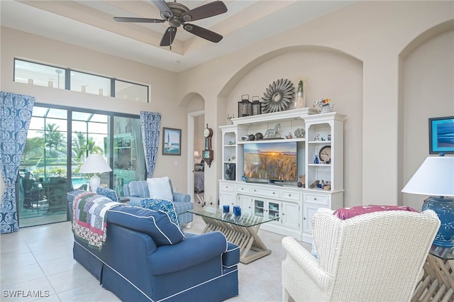 living room with a high ceiling, light tile patterned flooring, and ceiling fan