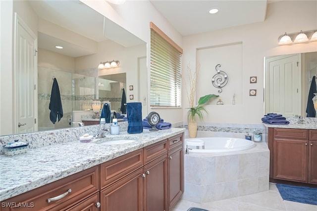 bathroom featuring vanity, plus walk in shower, and tile patterned flooring