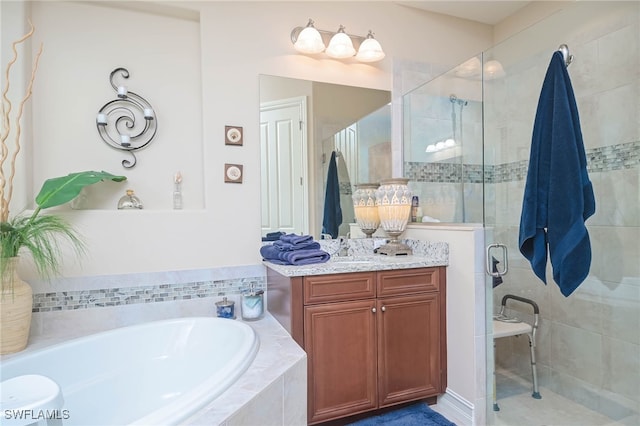 bathroom with independent shower and bath and vanity