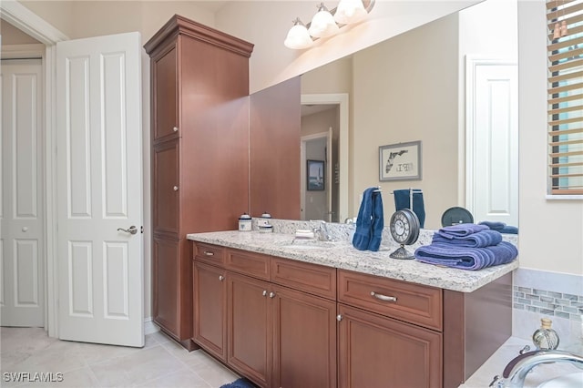 bathroom with tile patterned floors, vanity, and tasteful backsplash