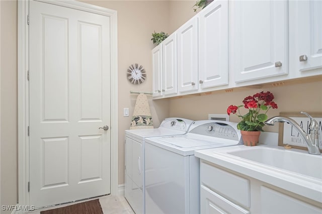 laundry area featuring cabinets, independent washer and dryer, and sink