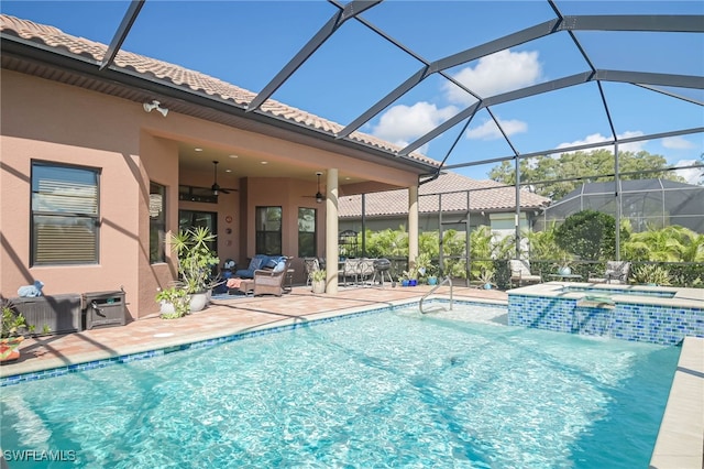 view of pool with a patio, outdoor lounge area, an in ground hot tub, glass enclosure, and ceiling fan