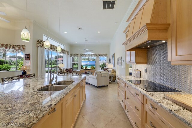 kitchen featuring pendant lighting, crown molding, light brown cabinetry, black electric stovetop, and sink