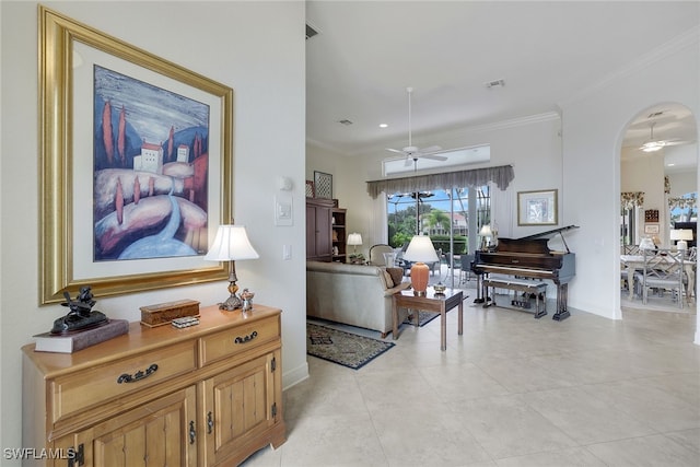 living room featuring crown molding, light tile patterned floors, and ceiling fan