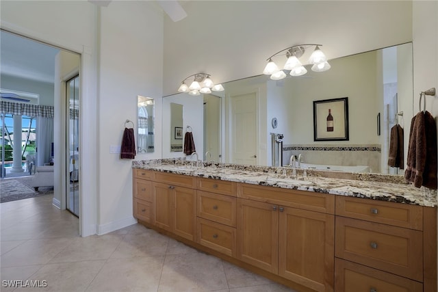 bathroom featuring a bath, vanity, and tile patterned floors