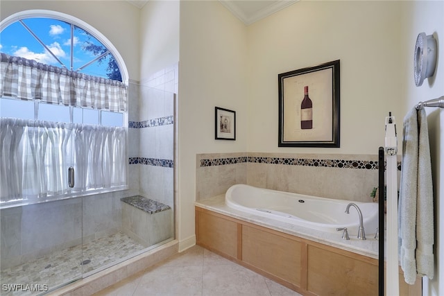 bathroom featuring plus walk in shower, tile patterned flooring, and ornamental molding