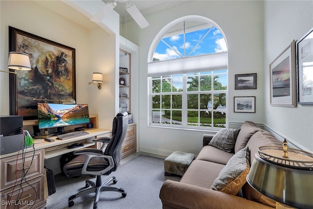 carpeted home office with ceiling fan