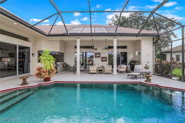 rear view of property featuring a patio, a lanai, ceiling fan, and an outdoor hangout area