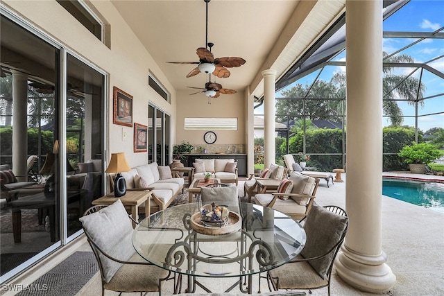 sunroom featuring ceiling fan