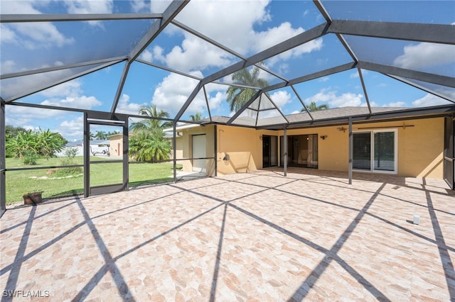 back of property with ceiling fan, a lanai, and a patio