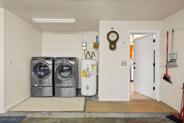 laundry area with washing machine and dryer and water heater