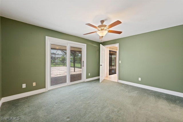 unfurnished room with ceiling fan and carpet